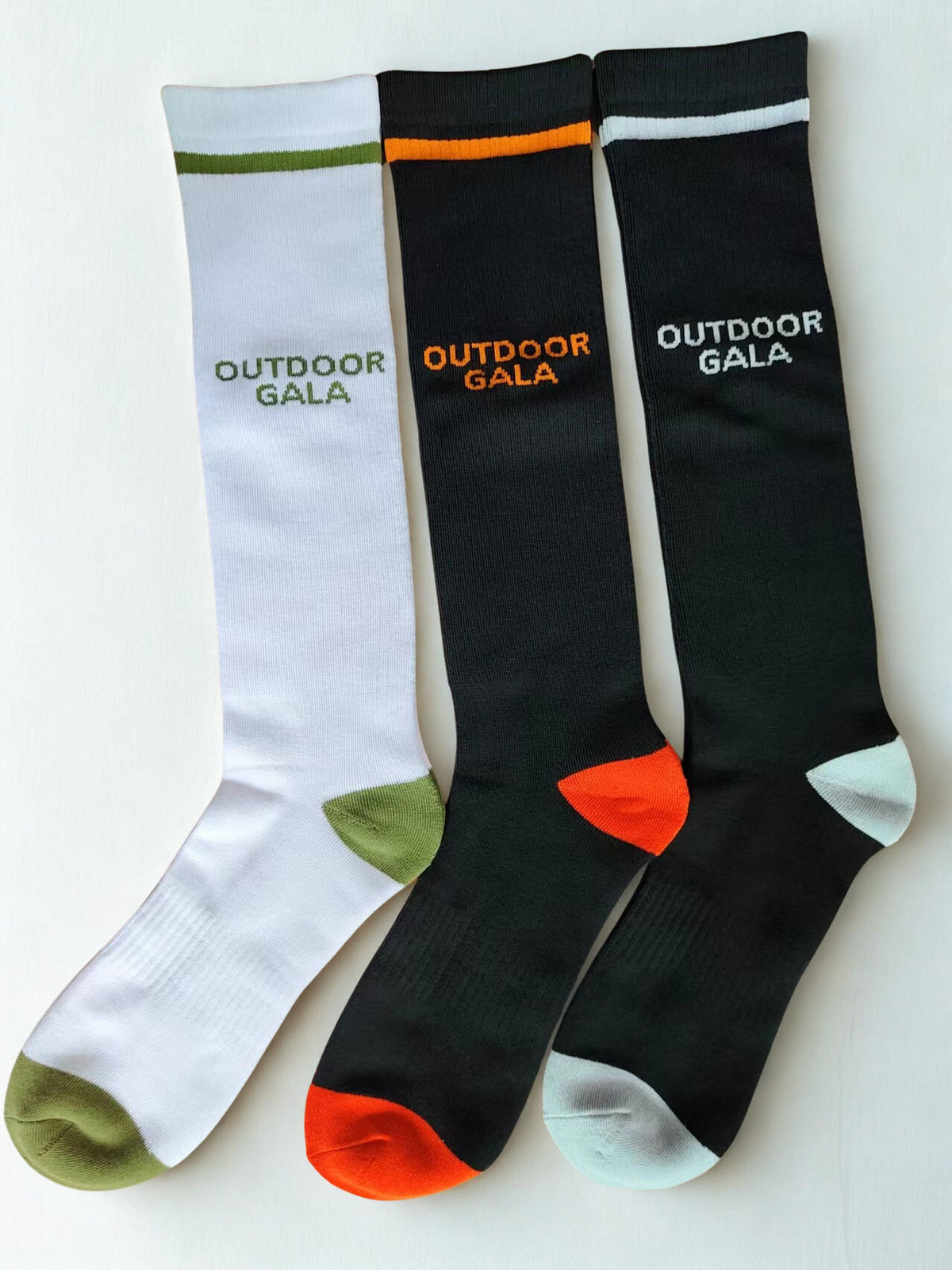 Outdoor Gala heated socks in White/Green, Black/Orange and Black/Silver (sold as one pair per colour)